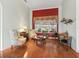 Comfortable living room featuring elegant decor, hardwood floors and a large window at 17652 Se 120Th Ter, Summerfield, FL 34491