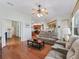 Open concept living room featuring wood floors and comfortable seating at 17652 Se 120Th Ter, Summerfield, FL 34491