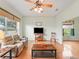 Open concept living room featuring wood floors, large windows, and ceiling fan at 17652 Se 120Th Ter, Summerfield, FL 34491