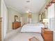 Comfortable main bedroom featuring plush carpeting, ceiling fan, and ensuite access at 17652 Se 120Th Ter, Summerfield, FL 34491