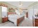 Spacious main bedroom with ceiling fan, and a large, comfortable bed at 17652 Se 120Th Ter, Summerfield, FL 34491