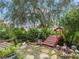 Lush backyard featuring a wooden bridge over a koi pond with a waterfall and manicured landscaping at 17652 Se 120Th Ter, Summerfield, FL 34491