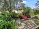 Beautiful backyard featuring a serene koi pond with a wooden bridge and lush landscaping at 17652 Se 120Th Ter, Summerfield, FL 34491