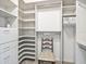 Custom walk-in closet features built-in shelving and hanging racks for organized storage at 17652 Se 120Th Ter, Summerfield, FL 34491