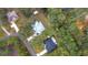 Aerial view of neighborhood with a white house in the center at 18315 Dells Cv, Groveland, FL 34736