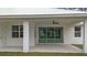 Covered patio with sliding glass doors and ceiling fan at 18315 Dells Cv, Groveland, FL 34736