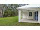 Covered patio with ceiling fan, adjacent to grassy backyard at 18315 Dells Cv, Groveland, FL 34736