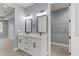 Elegant bathroom with double vanity, gray walls, and walk-in closet at 18315 Dells Cv, Groveland, FL 34736