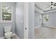 Simple half bathroom with gray walls and wood-look floors at 18315 Dells Cv, Groveland, FL 34736
