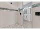 Stylish bathroom with double vanity and walk-in shower at 18315 Dells Cv, Groveland, FL 34736