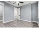Spacious bedroom with ceiling fan, walk-in closet, and wood-look flooring at 18315 Dells Cv, Groveland, FL 34736