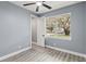 Bright bedroom with ceiling fan and wood-look flooring at 18315 Dells Cv, Groveland, FL 34736