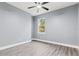 Bright bedroom with ceiling fan and wood-look flooring at 18315 Dells Cv, Groveland, FL 34736