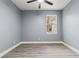 Bright bedroom with ceiling fan and wood-look flooring at 18315 Dells Cv, Groveland, FL 34736