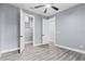 Spacious bedroom with ceiling fan, walk-in closet, and wood-look flooring at 18315 Dells Cv, Groveland, FL 34736