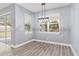 Simple dining room with light gray walls and wood-look floors at 18315 Dells Cv, Groveland, FL 34736