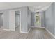 Bright entryway with gray walls, wood-look floors, and white doors at 18315 Dells Cv, Groveland, FL 34736