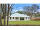 Home's rear elevation showcases patio and metal roof at 18315 Dells Cv, Groveland, FL 34736