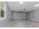 Spacious garage with overhead door and ample storage at 18315 Dells Cv, Groveland, FL 34736