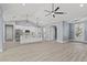Open concept kitchen with white cabinets, island, and stainless steel appliances at 18315 Dells Cv, Groveland, FL 34736