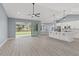 Spacious living room and kitchen with an open floor plan and sliding doors to the backyard at 18315 Dells Cv, Groveland, FL 34736
