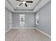 Spacious main bedroom with ceiling fan and en-suite bathroom at 18315 Dells Cv, Groveland, FL 34736
