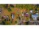 Aerial view of the lot featuring the home, other structures and vehicles at 18415 County Road 33, Groveland, FL 34736
