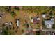 Aerial view of the home and lot outlined in red, with additional buildings and trees at 18415 County Road 33, Groveland, FL 34736
