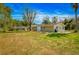 Backyard of a single-Gathering home, including a patio, grill, table and chairs at 18415 County Road 33, Groveland, FL 34736