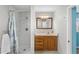 The bathroom features a shower, vanity with sink, and wooden cabinets at 18415 County Road 33, Groveland, FL 34736