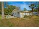 View of the exterior of a cozy home featuring a patio with table, chairs and a grill at 18415 County Road 33, Groveland, FL 34736