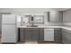 Bright kitchen equipped with modern appliances, gray cabinets and sleek countertops at 18415 County Road 33, Groveland, FL 34736