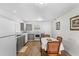Eat-in kitchen featuring sleek appliances, gray cabinets, and a dining area with seating at 18415 County Road 33, Groveland, FL 34736