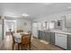 Eat-in kitchen with modern appliances, grey cabinets, and a bright open layout at 18415 County Road 33, Groveland, FL 34736