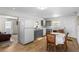 Bright eat-in kitchen featuring modern appliances, gray cabinets, and wood-look floors at 18415 County Road 33, Groveland, FL 34736