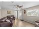 Inviting living room featuring neutral walls, wood-look flooring, and ample natural light at 18415 County Road 33, Groveland, FL 34736