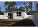 View of backyard with new white fence, sliding glass doors, large window and stucco exterior at 20145 Willow Cir, Mount Dora, FL 32757