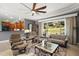 Comfortable living room showcasing tile floors, a stone fireplace, and an open design leading to other parts of the home at 2251 Lakeside Ter, Eustis, FL 32726