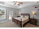 Bright main bedroom features a ceiling fan, and glass doors leading to a pool area at 2251 Lakeside Ter, Eustis, FL 32726