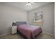 Neutral bedroom with a queen bed, bedside table, and large window providing natural light at 2455 Hastings Blvd, Clermont, FL 34711