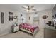 Cozy bedroom featuring a ceiling fan, window with blinds, and Florida State Seminoles themed decor at 2455 Hastings Blvd, Clermont, FL 34711