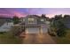 Beautiful two-story home with brick accents, three-car garage, and well-maintained brick paver driveway at 2455 Hastings Blvd, Clermont, FL 34711