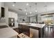 Open concept kitchen with a center island, stainless steel appliances, and seamless flow to the living spaces at 2455 Hastings Blvd, Clermont, FL 34711