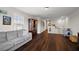 Bright living area featuring wood floors, a gray sofa, and natural light from the window at 2455 Hastings Blvd, Clermont, FL 34711