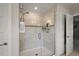 Walk-in shower featuring seamless glass door and built-in shelves at 2455 Hastings Blvd, Clermont, FL 34711