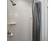 Shower stall with white tiles and a shower curtain at 25229 Mardon Cir, Paisley, FL 32767