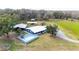 Aerial view of the home and property showing the pool, deck, and outbuildings at 2685 Cr 776, Webster, FL 33597
