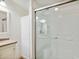 Bathroom features a shower with glass doors, granite counters, and white cabinets at 2685 Cr 776, Webster, FL 33597