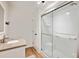 Bathroom featuring a glass-enclosed shower, granite countertop vanity, and wood-look flooring at 2685 Cr 776, Webster, FL 33597