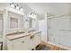 Bright bathroom featuring double vanity, granite countertops, and a glass-enclosed shower at 2685 Cr 776, Webster, FL 33597